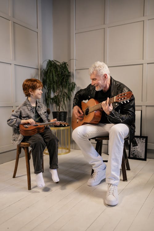 Grandfather Teaching His Grandson on How to Play the Guitar