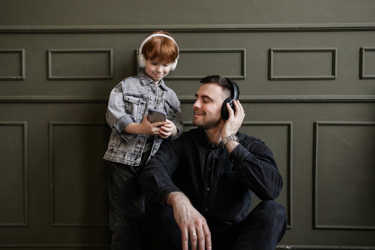 Father And Son Listening To Music