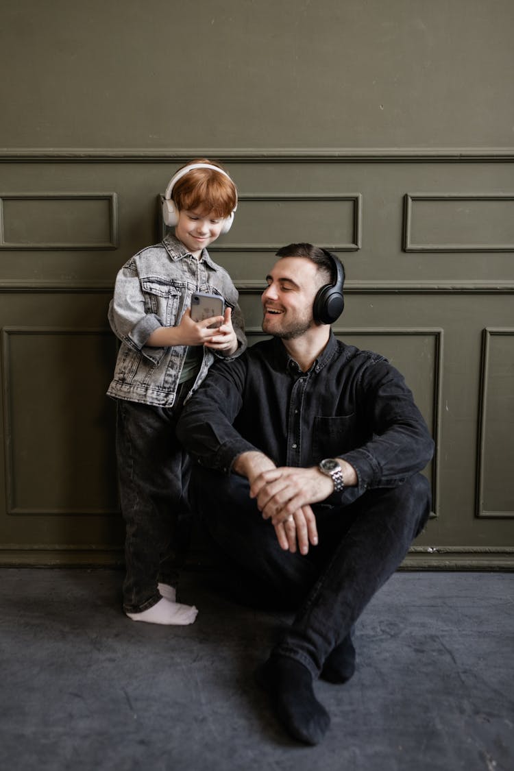 Father And Son Listening To Music