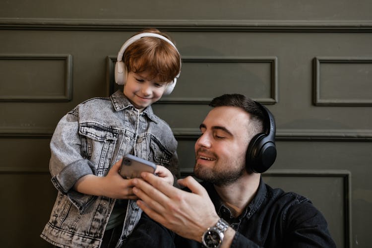 Father And Son Listening To Music