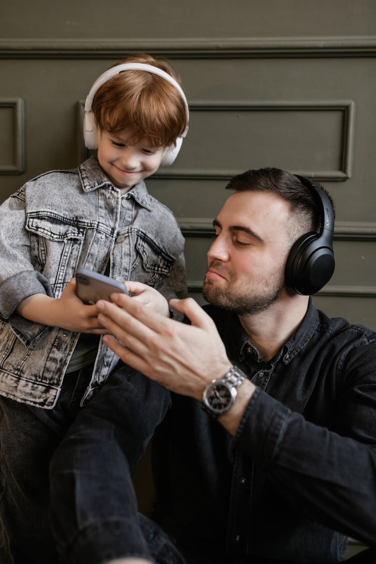 Father And Son Listening To Music