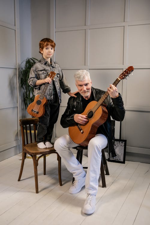 Grandfather and Grandson Holding Their String Instruments