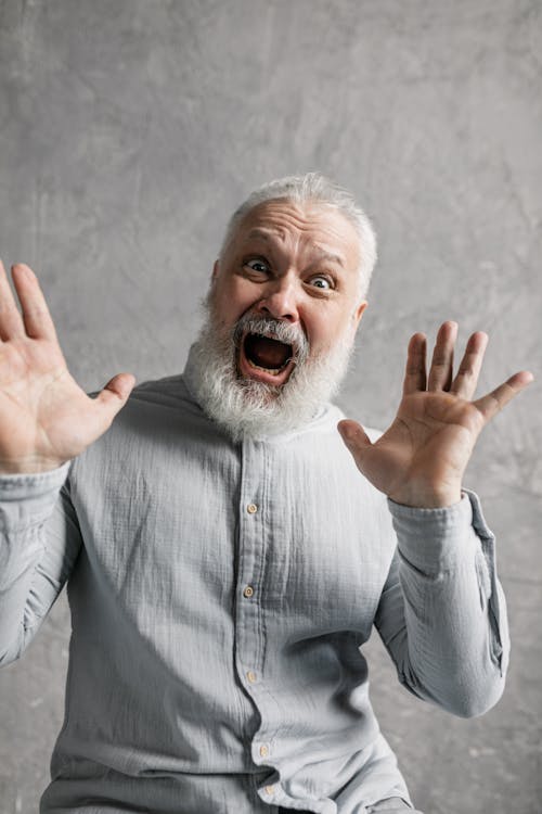 Elderly Man in Gray Long Sleeves Looking Surprised