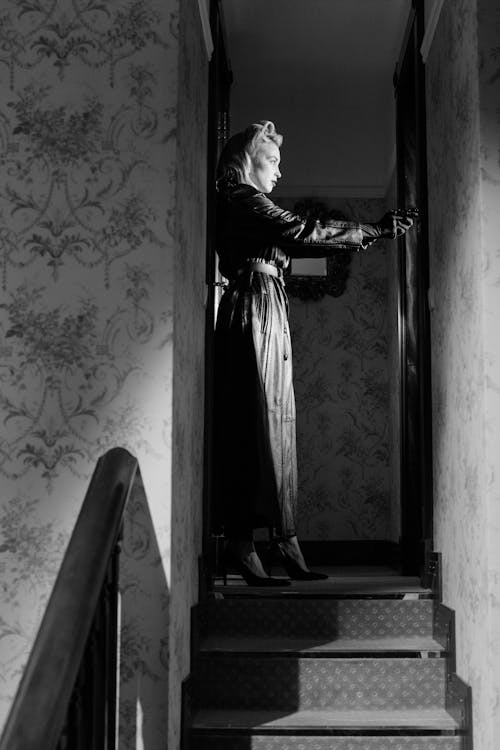 Woman in Black Coat Standing on Stairs