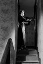 Woman in Black Coat Standing on Stairs