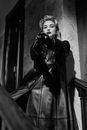 Grayscale Photo of Woman Standing on the Stairs