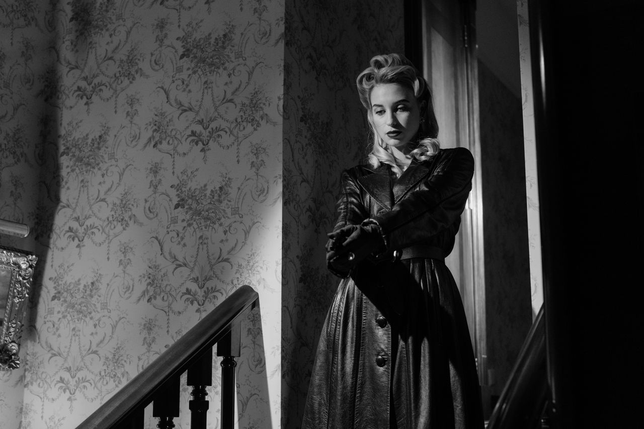 elegant black and white portrait of a mysterious femme fatale in a vin