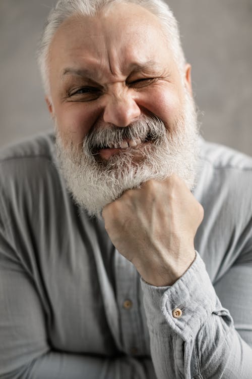 Elderly Man in Gray Long Sleeves Winking