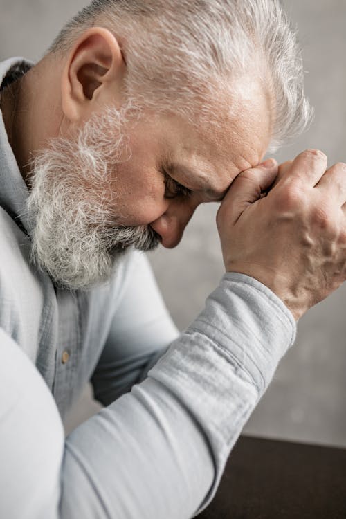 Elderly Man in Gray Long Sleeve Shirt Thinking Deeply