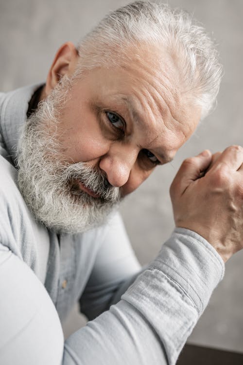 Elderly Man in Gray Long Sleeve Shirt Thinking Deeply