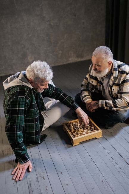 Diverse group of U.S. Veterans playing chess together, highlighting social connection and community building