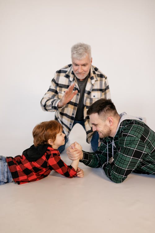 A Family Having Fun Playing Arm Wrestling