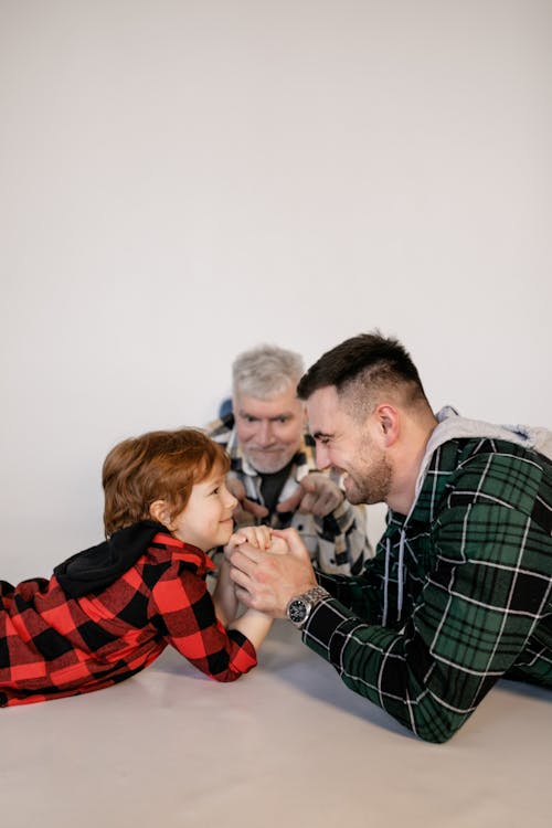 Free A Family Having Fun Playing Arm Wrestling Stock Photo
