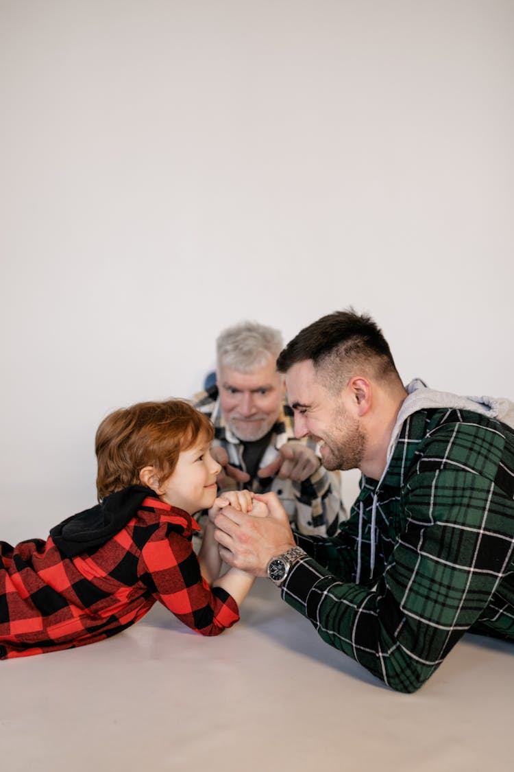 A Family Having Fun Playing Arm Wrestling