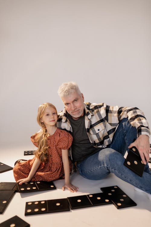 Grandfather and Granddaughter Playing Giant Lawn Dominoes