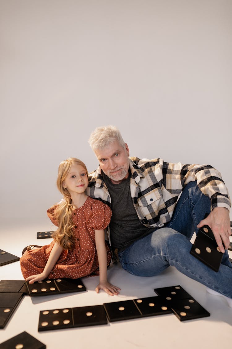 Grandfather And Granddaughter Playing Giant Lawn Dominoes