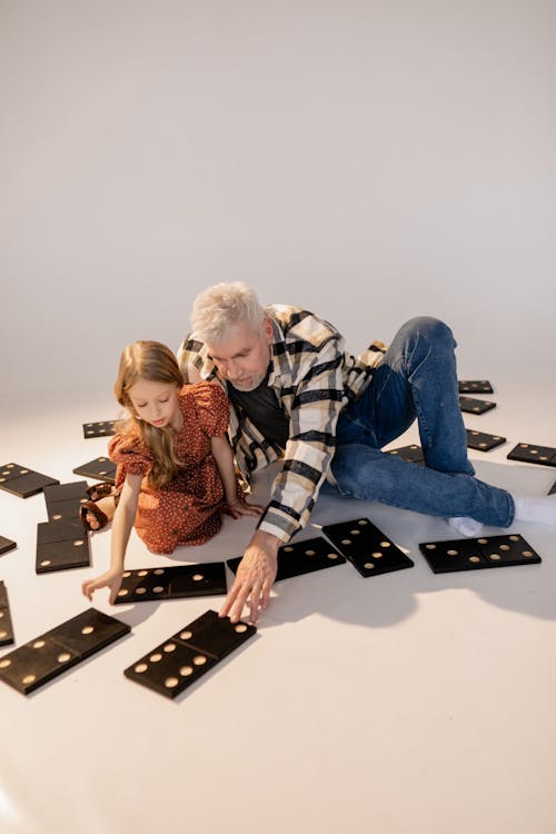 Grandfather and Granddaughter Playing Giant Lawn Dominoes