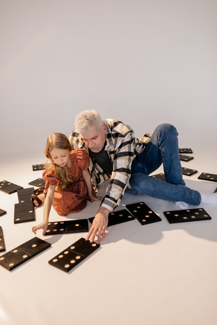 Grandfather And Granddaughter Playing Giant Lawn Dominoes