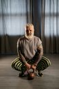 An Elderly Man Holding a Kettlebell