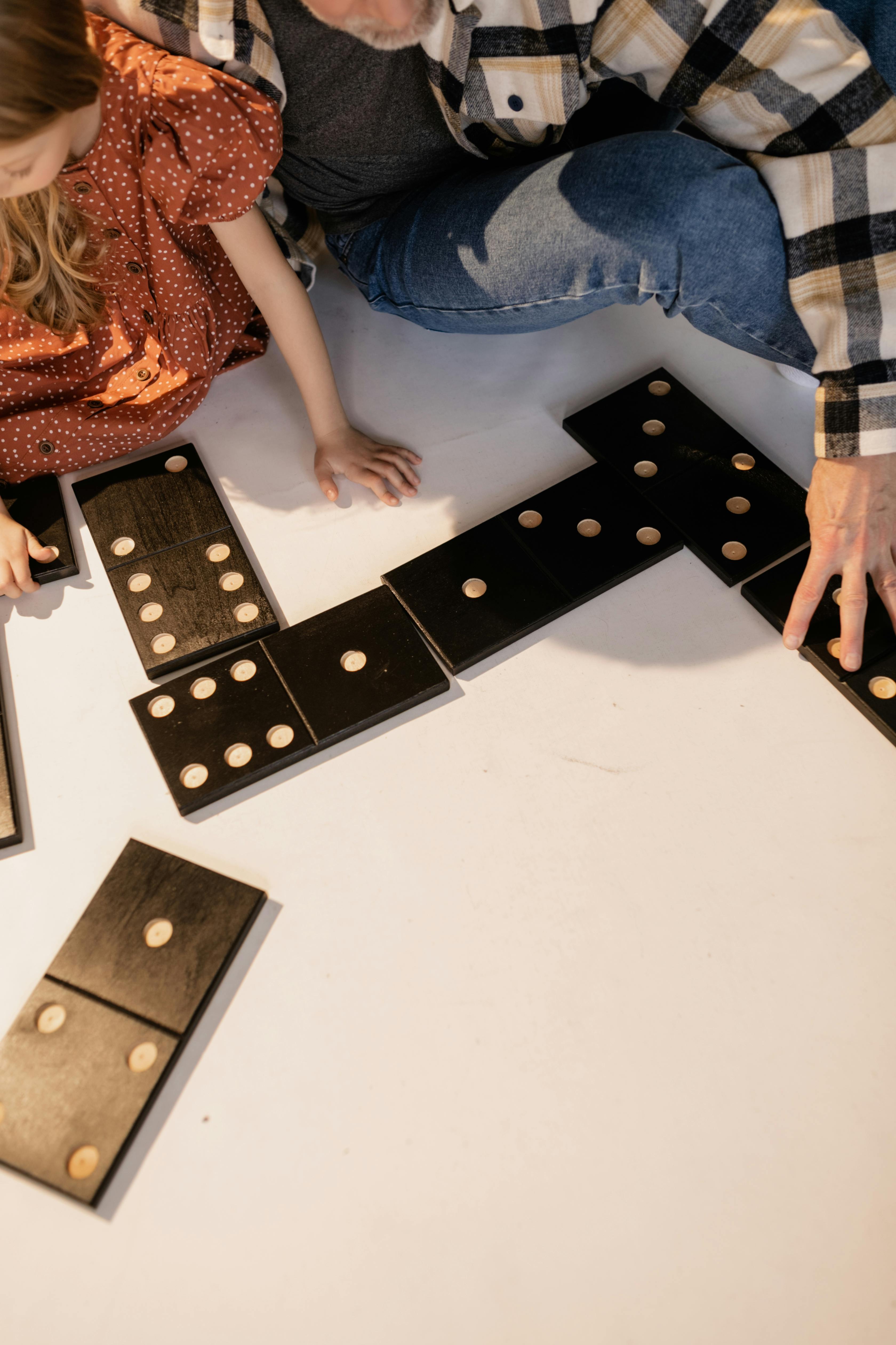 grandfather and granddaughter playing giant lawn dominoes