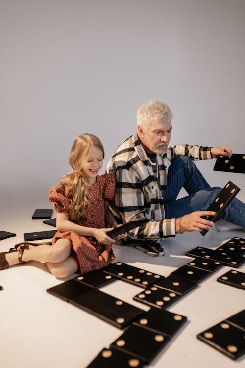 Grandfather and Granddaughter Playing Giant Lawn Dominoes