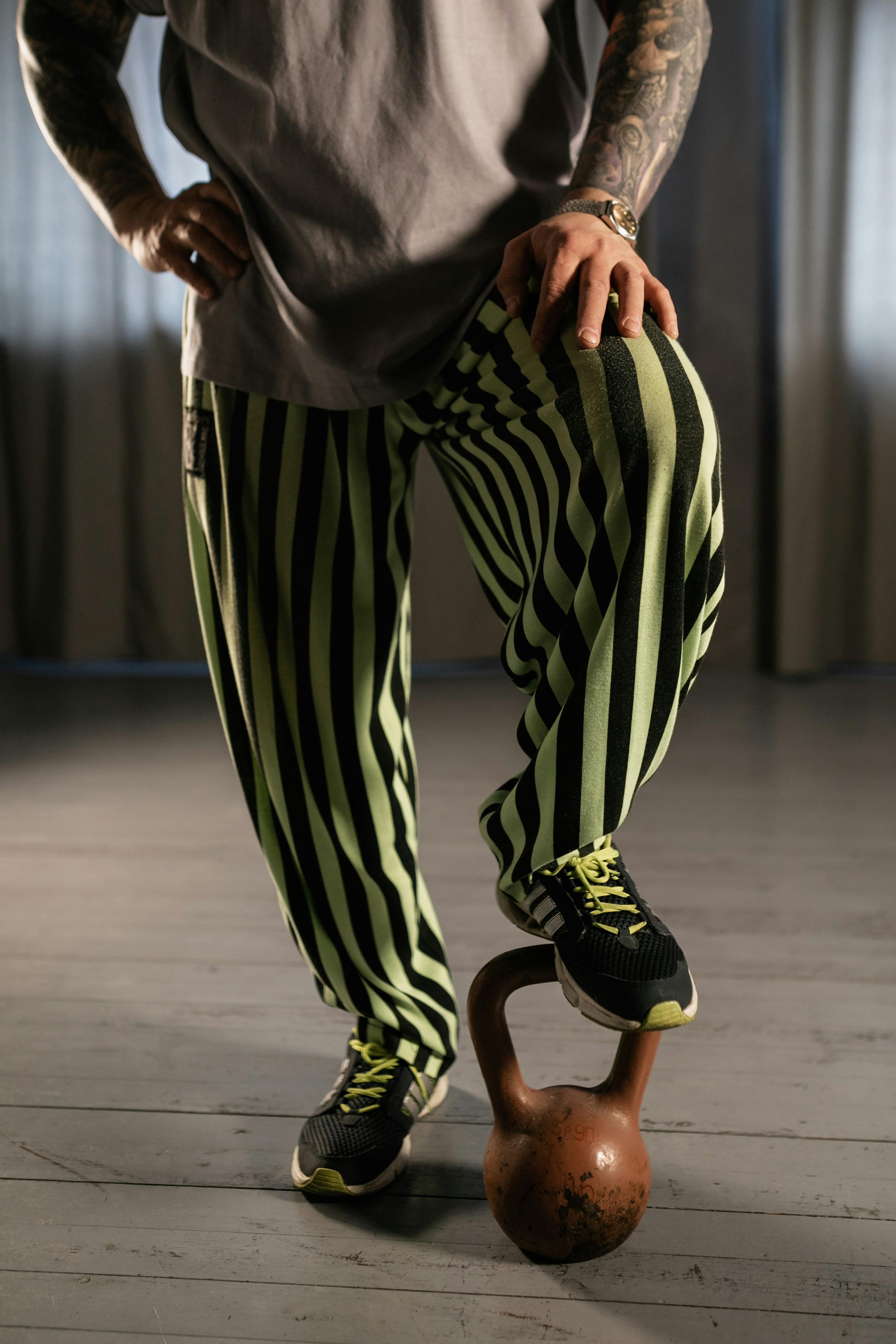 person stepping on a kettlebell