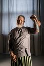 An Elderly Man Holding a Kettlebell