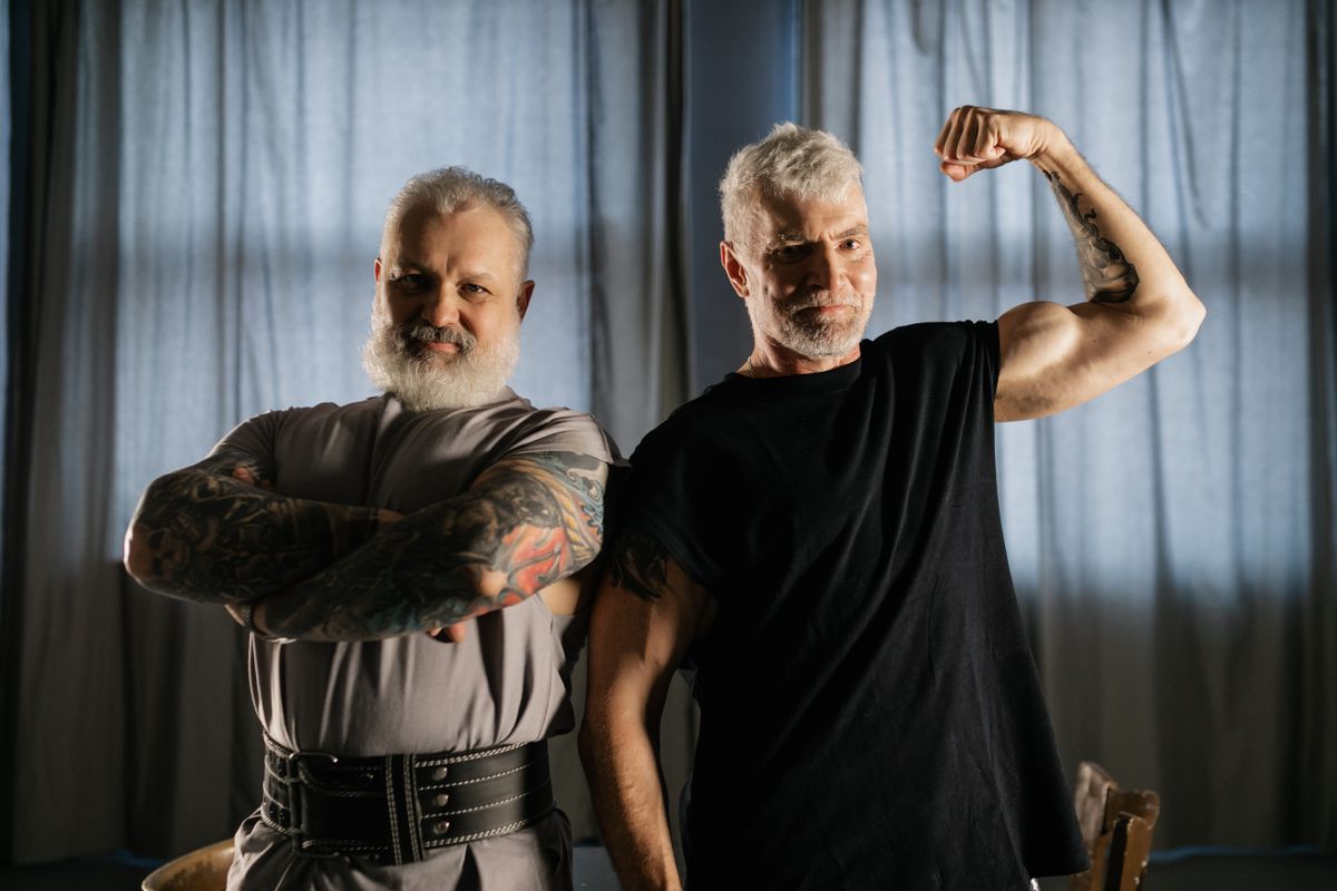Elderly men flexing and showing their muscles, demonstrating strength and positive aging