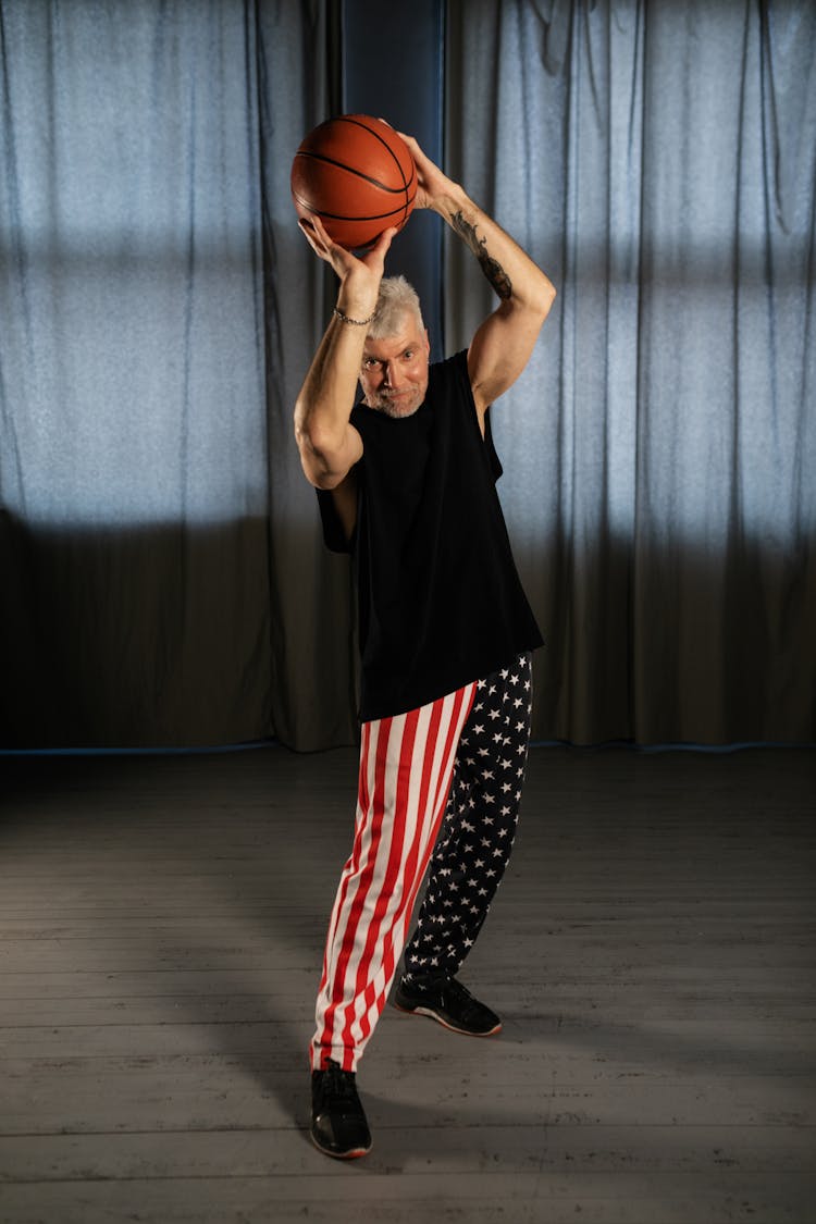 Elderly Man Holding A Basketball