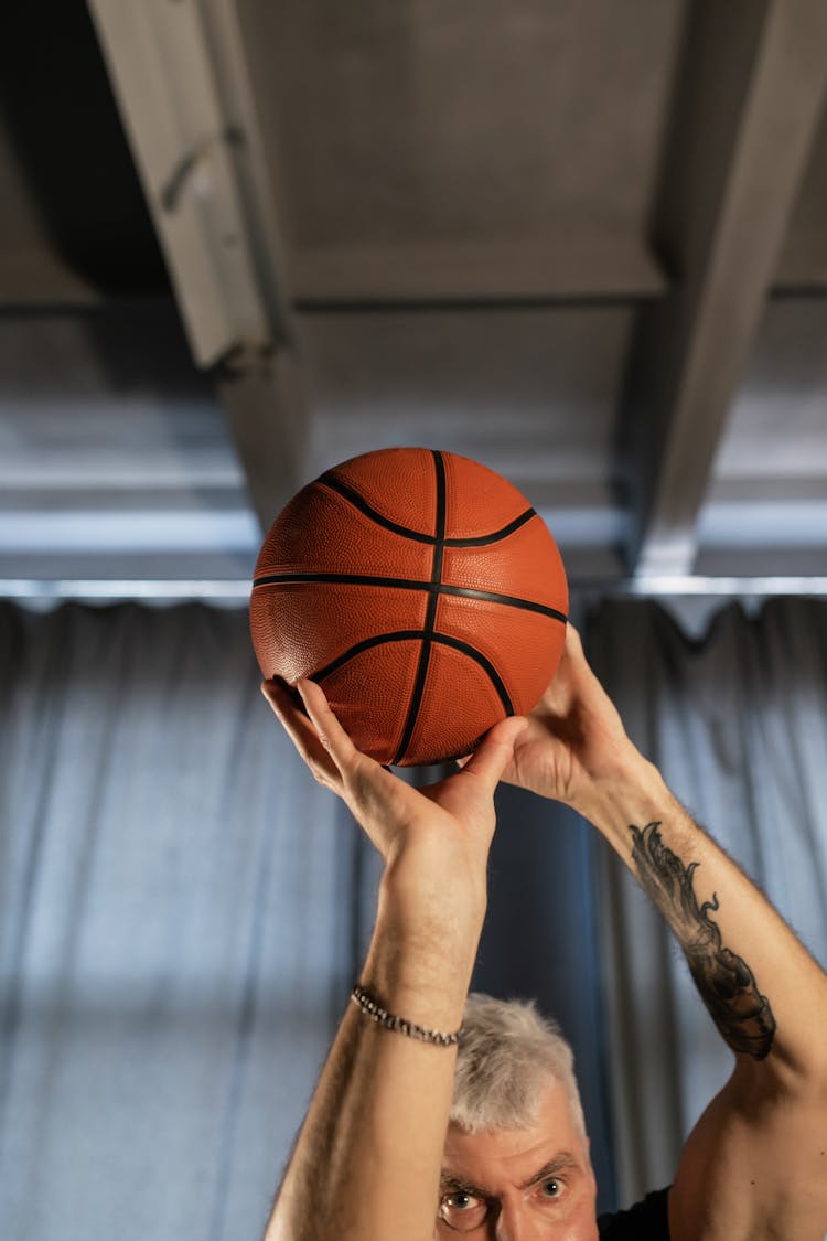 Elderly Man Holding A Basketball