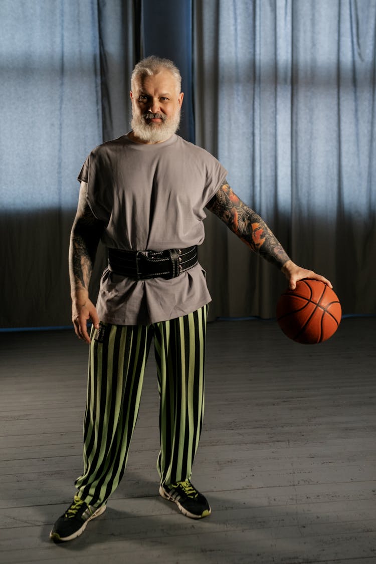 Elderly Man Holding A Basketball