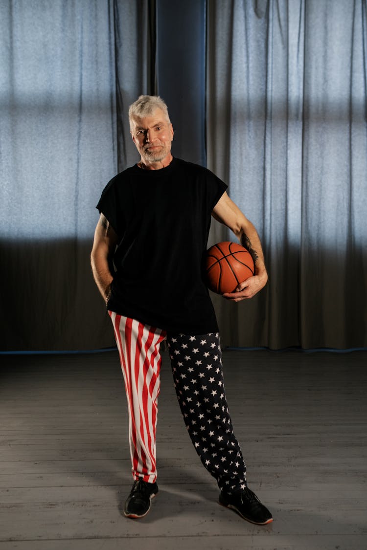 Elderly Man Holding A Basketball