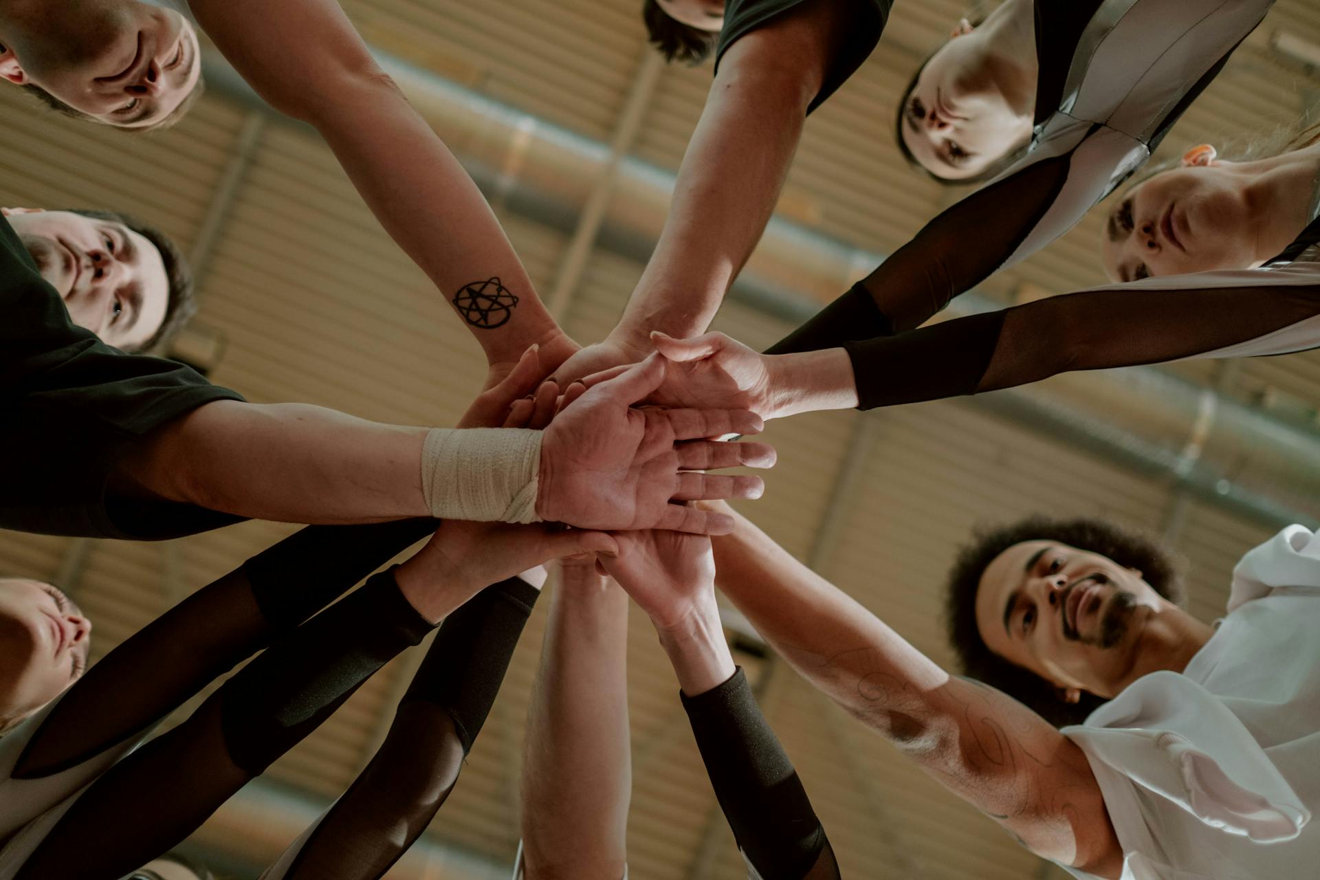 Group of People Joining Hands Together