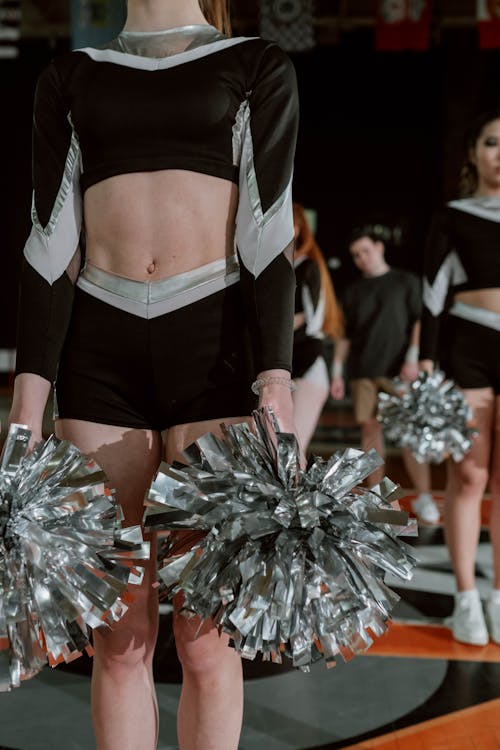 Cheerleaders In Uniform Holding Pom-Poms Stock Photo, Picture and Royalty  Free Image. Image 5428495.