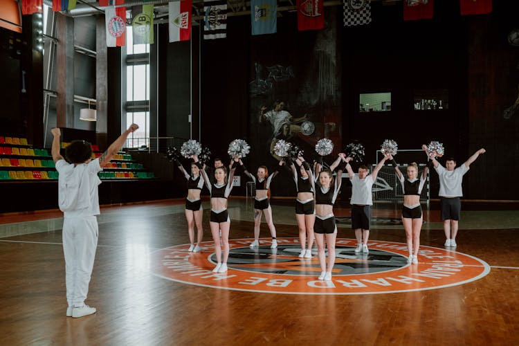 Cheering Squad Rehearsing At A Basketball Court