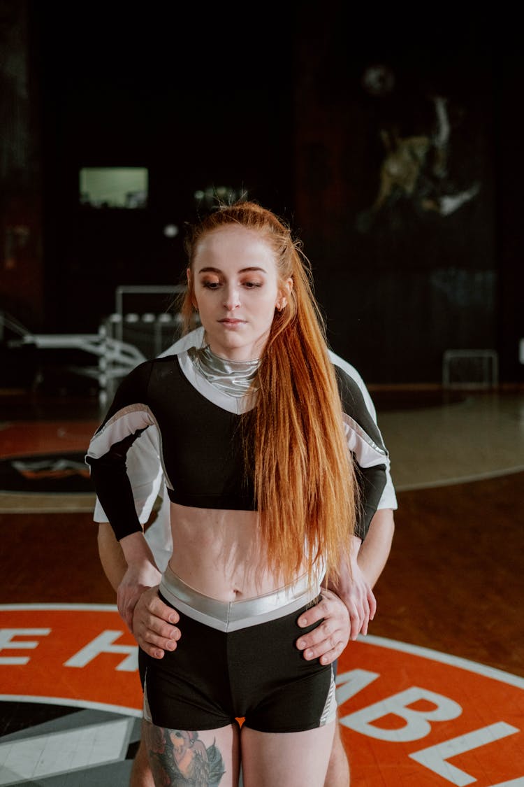 A Woman In Black And White Cheerleader Uniform