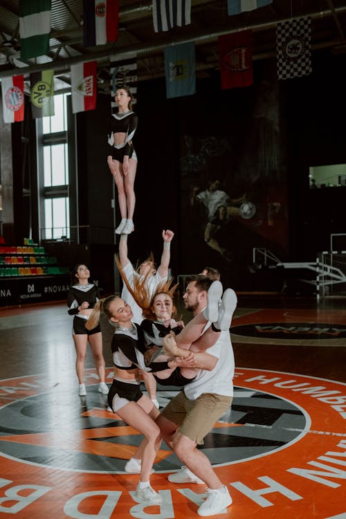 Free Cheerleaders Performing at the Gym Stock Photo