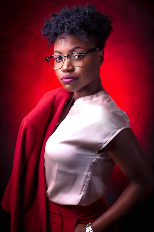 Woman in White Blouse Holding Her Red Blazer