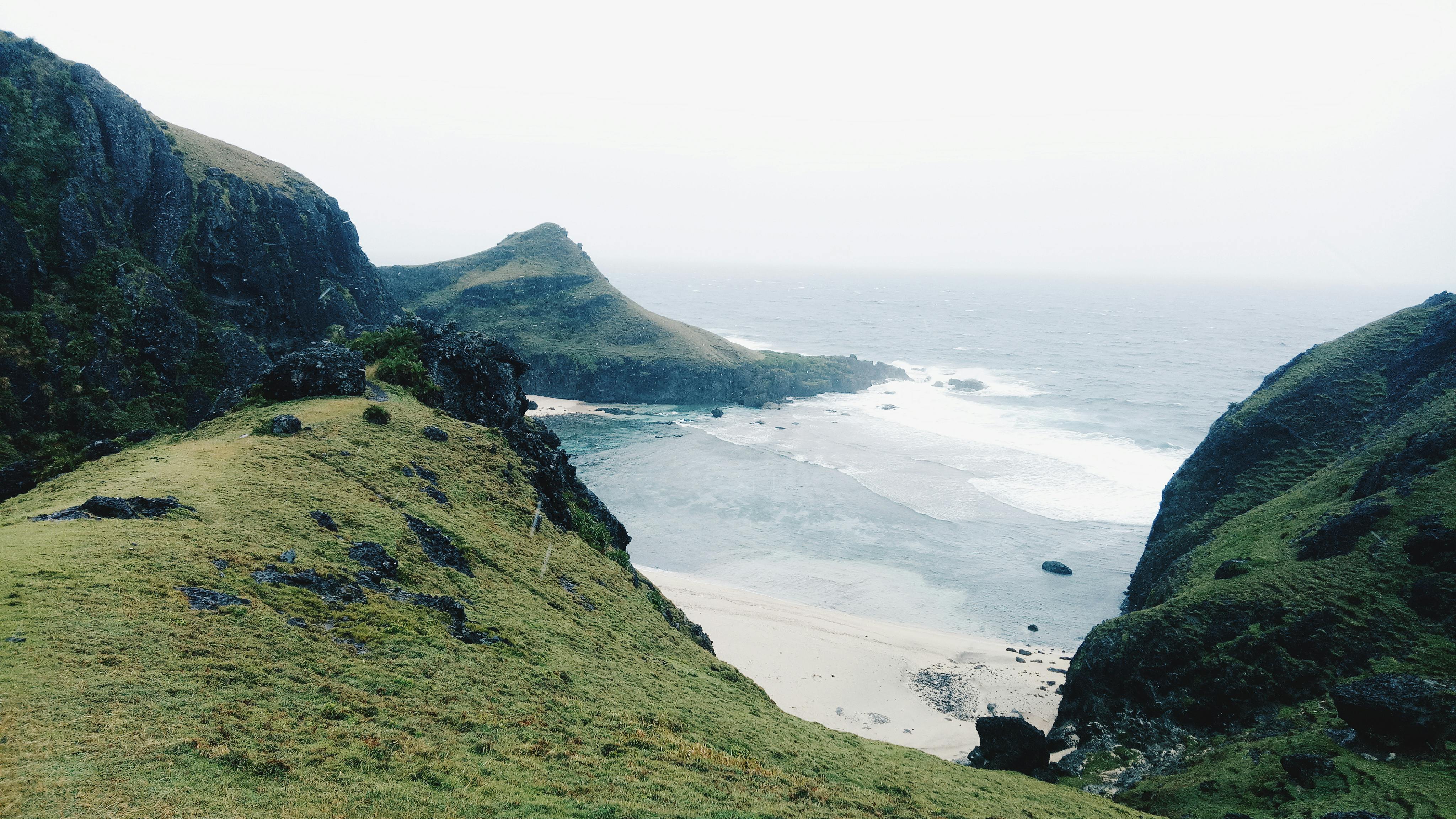 green mountain ruins near seashore