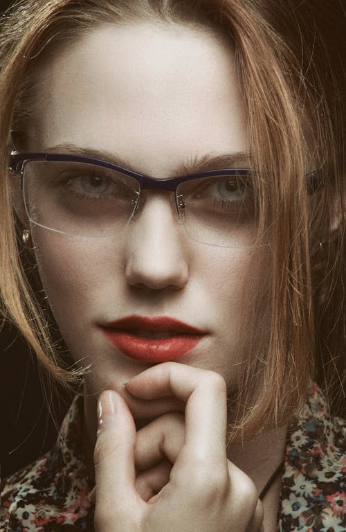 Portrait of a Woman with Red Lips Wearing Purple Framed Eyeglasses