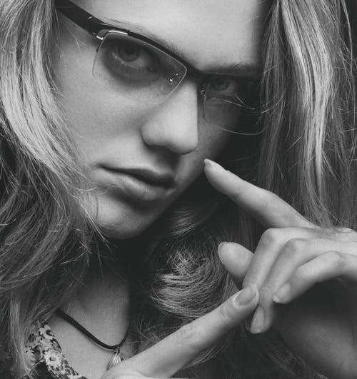 Close Up Photo of a Woman Wearing Eyeglasses