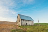 Photo of Beige and Gray Wooden Barn House on Green Grass