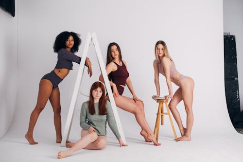 Women Posing with a Stepladder and a Bar Stool