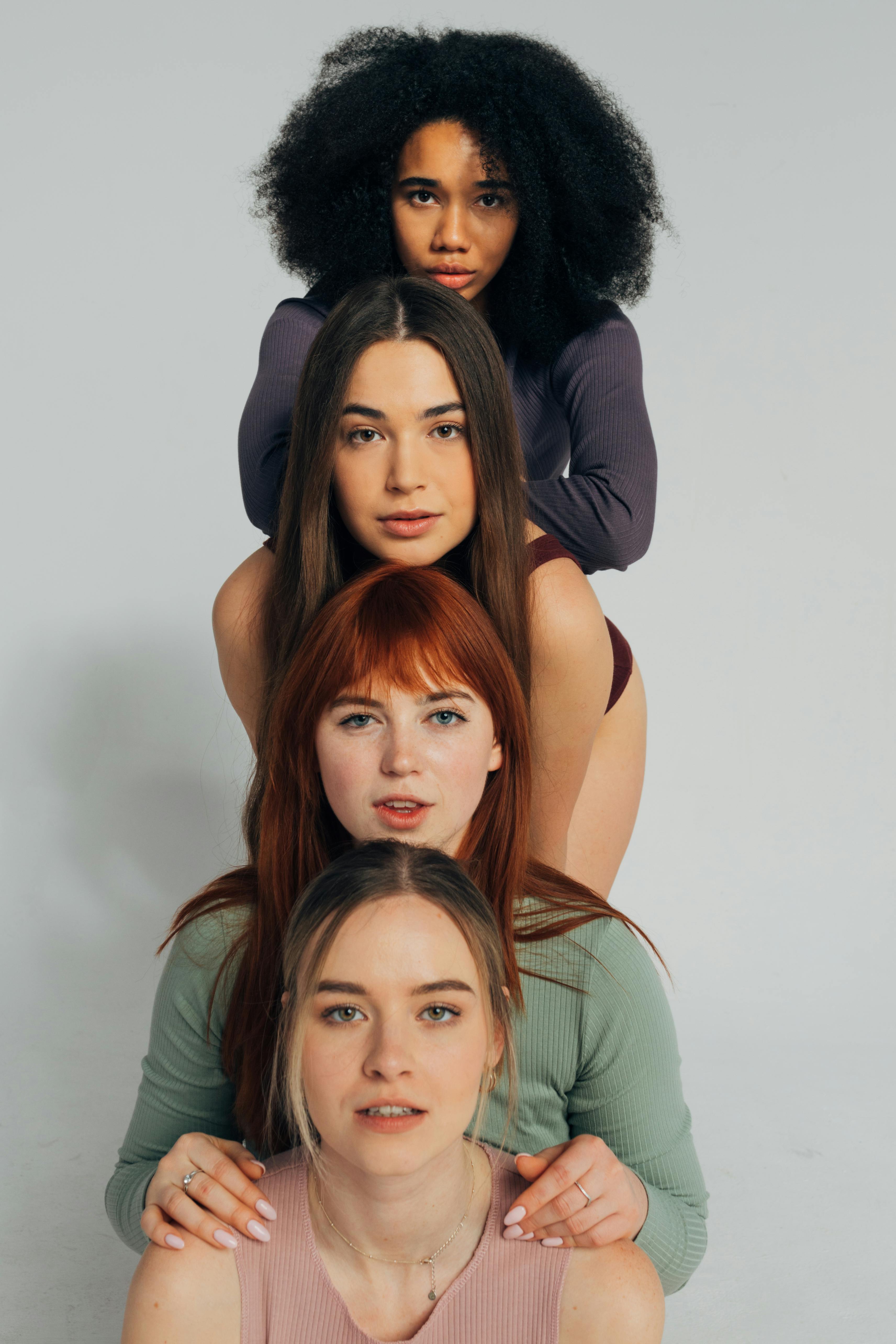 A stylish portrait of four diverse young women showcasing confidence and femininity.