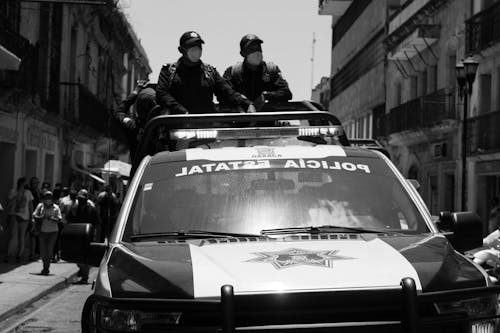 Policemen Standing at the Back of a Pickup Truck