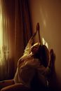 Sensual model with tattoos at home in sunrays