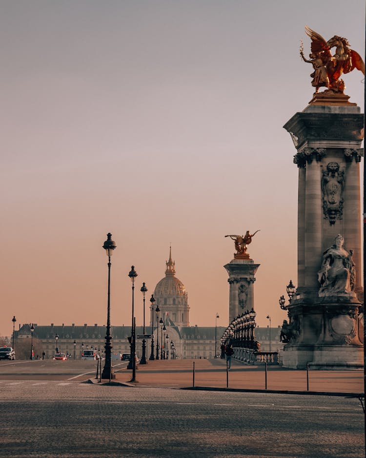 Walkway Of The Pont Alexandre III Bridge With The Des Invalides Hotel On Background In Paris, France