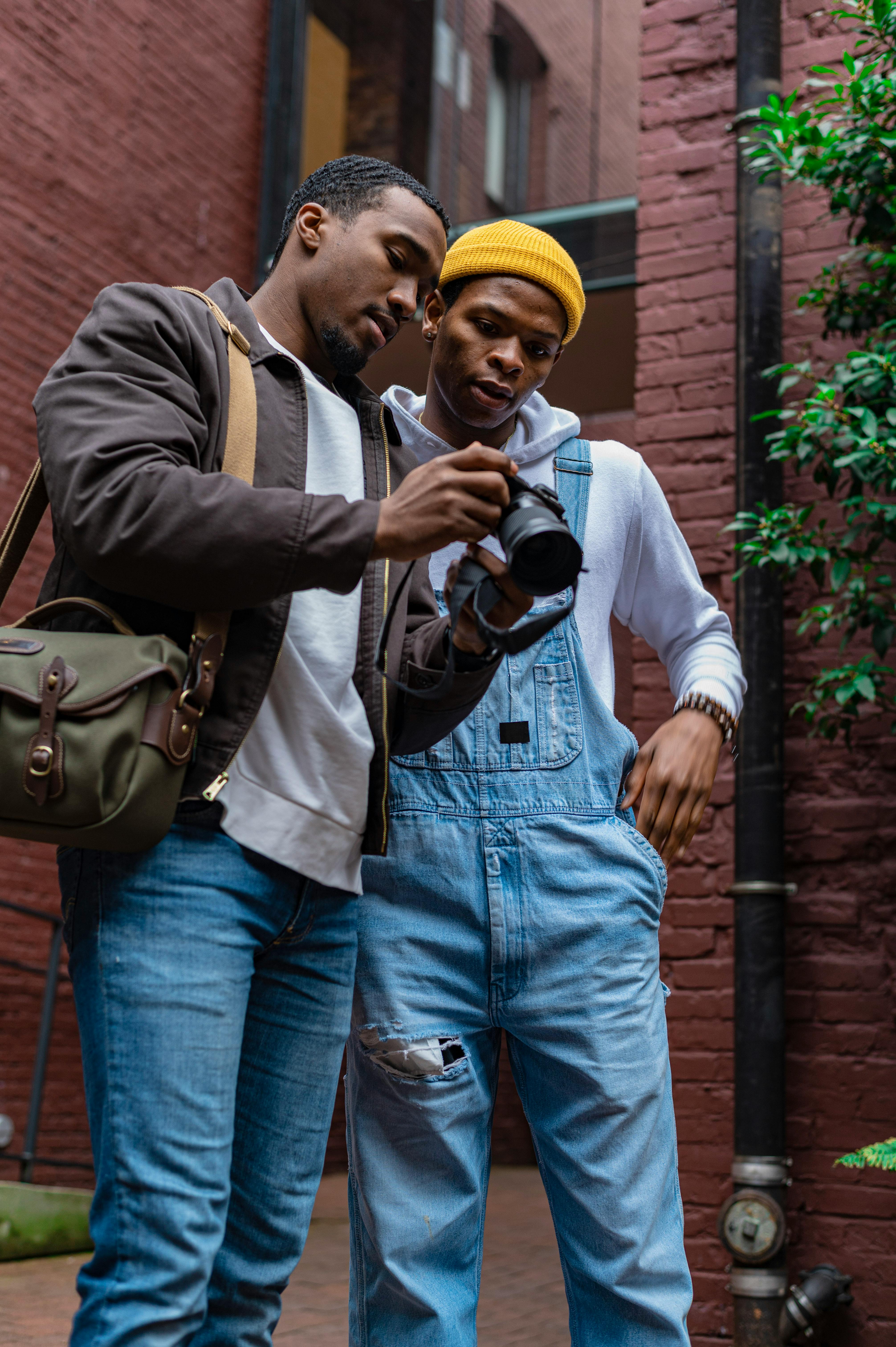 photographer showing the model the picture that he took of him