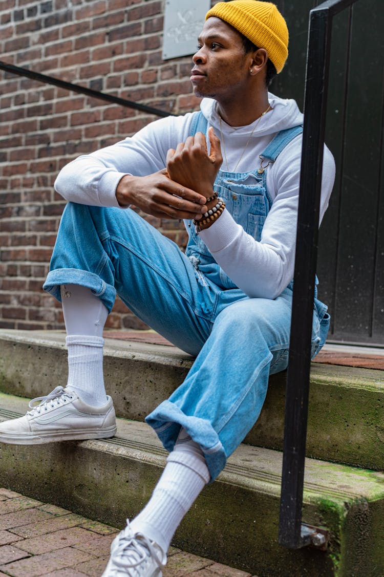 Man In Blue Denim Jumpsuit Sitting On Concrete Stairs