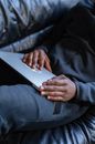 Person in Black Long Sleeve Shirt Holding White Paper